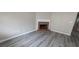 Living room with fireplace and grey wood-look flooring at 6627 Coventry Pt, Austell, GA 30168