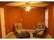 Comfortable bedroom featuring two lounge chairs and a ceiling fan at 10252 Commons Xing, Jonesboro, GA 30238