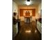 Bright kitchen with white cabinets, wood floors, breakfast bar and stainless appliances at 10252 Commons Xing, Jonesboro, GA 30238