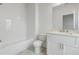 Bright bathroom featuring a subway tile shower, white vanity, and modern fixtures at 11335 Bennett Ln, Johns Creek, GA 30097