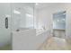 Luxurious bathroom featuring a glass shower, soaking tub, and bright natural light at 11335 Bennett Ln, Johns Creek, GA 30097