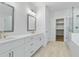 Modern bathroom with double vanity, walk-in shower, and walk-in closet at 11335 Bennett Ln, Johns Creek, GA 30097