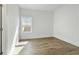 Well-lit bedroom with wood floors and a window at 11335 Bennett Ln, Johns Creek, GA 30097