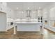 Modern kitchen showcases an island, stainless appliances, and white cabinets offering ample storage and style at 11335 Bennett Ln, Johns Creek, GA 30097