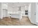 Modern kitchen features an island, stainless steel appliances, and sleek white cabinetry offering abundant storage at 11335 Bennett Ln, Johns Creek, GA 30097