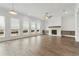 Bright living room boasts a fireplace, ample windows, and wood-look flooring for a contemporary aesthetic at 11335 Bennett Ln, Johns Creek, GA 30097
