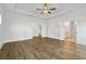 Bright main bedroom with wood floors, ceiling fan, and multiple entryways at 11335 Bennett Ln, Johns Creek, GA 30097