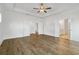 Bright main bedroom with wood floors, recessed lighting, ceiling fan, and doorways to the en suite at 11335 Bennett Ln, Johns Creek, GA 30097