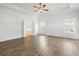 Spacious main bedroom featuring wood floors, ceiling fan, and ensuite bathroom at 11335 Bennett Ln, Johns Creek, GA 30097