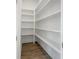 Walk-in pantry features ample white shelving and hardwood floors for convenient storage at 11335 Bennett Ln, Johns Creek, GA 30097