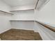 Large walk-in closet with wood shelving, ample storage, and wood flooring at 11335 Bennett Ln, Johns Creek, GA 30097