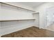 Functional walk-in closet featuring rod and shelf storage, with view to the bright and modern bathroom at 11335 Bennett Ln, Johns Creek, GA 30097