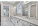 Bathroom featuring double vanity with white cabinets, quartz countertop, and two mirrors at 161 Mooney Rd, Woodstock, GA 30188