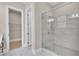 Luxurious bathroom with glass enclosed shower, tile surround and open door to walk-in closet at 161 Mooney Rd, Woodstock, GA 30188