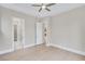 Neutral bedroom features two doorways and a ceiling fan at 161 Mooney Rd, Woodstock, GA 30188