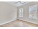 Bedroom featuring two bright windows, neutral walls, and a ceiling fan at 161 Mooney Rd, Woodstock, GA 30188