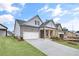Attractive single-Gathering home with brick accents, well-kept lawn, and a two-car garage at 161 Mooney Rd, Woodstock, GA 30188