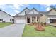 Charming home featuring a brick facade, inviting front porch, and a well-manicured lawn at 161 Mooney Rd, Woodstock, GA 30188