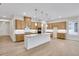Spacious kitchen with an island, granite countertops, stainless steel appliances, and modern lighting at 161 Mooney Rd, Woodstock, GA 30188