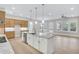 Spacious kitchen with an island, granite countertops, stainless steel appliances, and modern lighting at 161 Mooney Rd, Woodstock, GA 30188