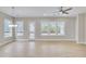 Bright living room features hardwood floors, a modern chandelier, and natural light from large windows at 161 Mooney Rd, Woodstock, GA 30188