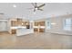 Expansive living area with open kitchen, featuring hardwood floors, recessed lighting, and a modern ceiling fan at 161 Mooney Rd, Woodstock, GA 30188