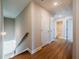 Upstairs hallway with access to a bathroom and linen closet, featuring wood floors and natural light at 1700 Fulmont Circle, Mableton, GA 30126