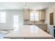 Kitchen featuring a large center island with white marble countertop and gray cabinets and stainless steel appliances at 1700 Fulmont Circle, Mableton, GA 30126