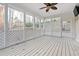 Bright screened porch with wood flooring and ceiling fan at 3502 Rain Tree Ct, Douglasville, GA 30135