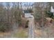 Aerial view of a home with a long driveway surrounded by mature trees at 1012 Crown River Pkwy, Mcdonough, GA 30252