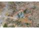 Bird's eye view of a quaint home and its yard, surrounded by dense trees in a lovely neighborhood at 1012 Crown River Pkwy, Mcdonough, GA 30252