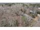 An aerial view of a home in a wooded area with a long driveway and well-maintained landscaping at 1012 Crown River Pkwy, Mcdonough, GA 30252
