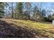 Lawn area in a private backyard with mature trees and a gentle slope at 1012 Crown River Pkwy, Mcdonough, GA 30252
