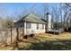 Fenced backyard with a deck, lush grass, and mature trees offering privacy at 1012 Crown River Pkwy, Mcdonough, GA 30252