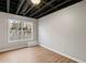Finished basement featuring exposed ceiling and a double-hung window at 1012 Crown River Pkwy, Mcdonough, GA 30252