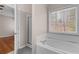 Primary bathroom featuring a standalone tub, glass shower, and access to the bedroom at 1012 Crown River Pkwy, Mcdonough, GA 30252