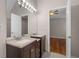 Bathroom featuring double sinks and opening to a bedroom with wood floors at 1012 Crown River Pkwy, Mcdonough, GA 30252