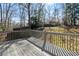 Backyard view featuring a deck and a peaceful, tree-lined landscape at 1012 Crown River Pkwy, Mcdonough, GA 30252
