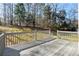 Wooden deck with railing overlooking a grassy yard with mature trees at 1012 Crown River Pkwy, Mcdonough, GA 30252