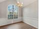 Spacious dining room with chandelier, large arched window and hardwood floors at 1012 Crown River Pkwy, Mcdonough, GA 30252