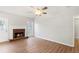 Bright living room with wood floors, fireplace, and natural light streaming through the windows at 1012 Crown River Pkwy, Mcdonough, GA 30252