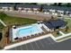 Aerial view of the community pool with lounge chairs, umbrellas, and clubhouse, surrounded by modern townhomes at 1582 Driggs Nw Dr # 169, Atlanta, GA 30318