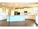 Spacious kitchen with large island, white cabinets, and granite countertops at 416 Aristides Way, Canton, GA 30115
