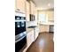 Modern kitchen with stainless steel appliances and white cabinetry at 416 Aristides Way, Canton, GA 30115