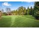 A large and well-manicured backyard with expansive green lawns and mature landscaping at 511 Baxter Way, Marietta, GA 30064