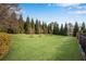 Expansive backyard with a lush green lawn, mature trees, and a fence line. A great space for outdoor activities at 511 Baxter Way, Marietta, GA 30064