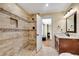 Beautiful bathroom featuring a tiled walk-in shower, granite vanity, and a view into an adjacent bedroom at 511 Baxter Way, Marietta, GA 30064