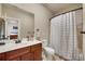 Bathroom featuring a vanity with dark wood cabinets and a shower with patterned curtains at 511 Baxter Way, Marietta, GA 30064
