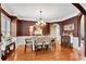 Elegant dining room with hardwood floors, wainscoting, a chandelier, and ample natural light at 511 Baxter Way, Marietta, GA 30064