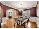 Formal dining room featuring a chandelier, hardwood floors, large windows, and table setting at 511 Baxter Way, Marietta, GA 30064